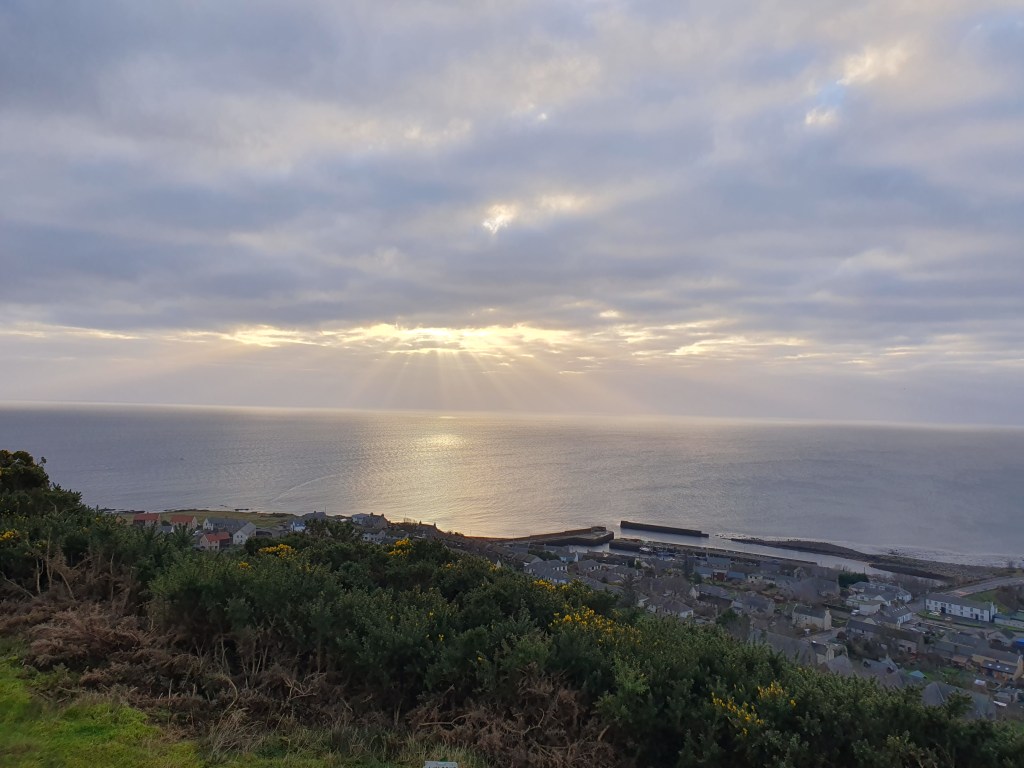 A moment of Joy during a walk - The sun breaking through clouds and shining on to the sea off the coast of Helmsdale, from 'Helmsdale Rock'